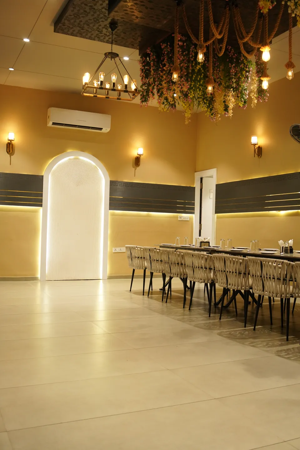 Luminous banquet hall with a lit arch and floral ceiling