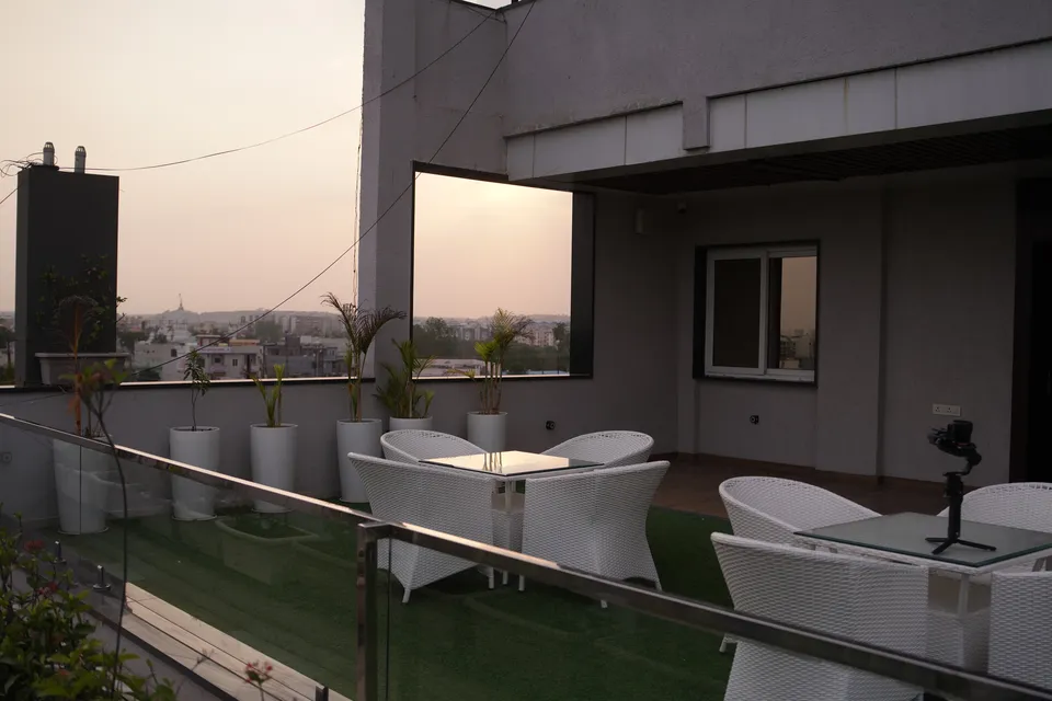 The Deck rooftop at dusk with a golden Bhopal sky